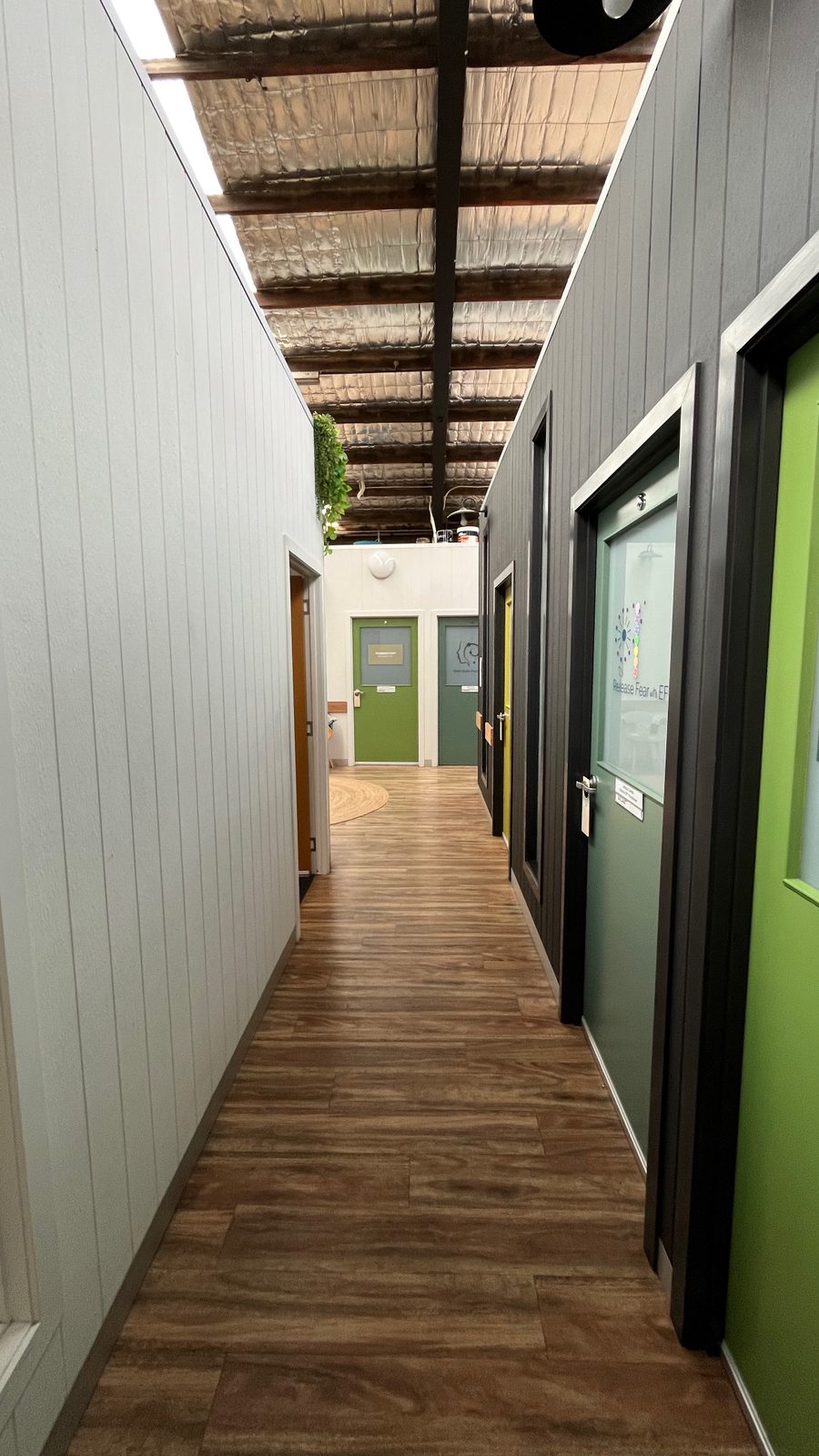 Hallway with individually coloured practitioner room doors