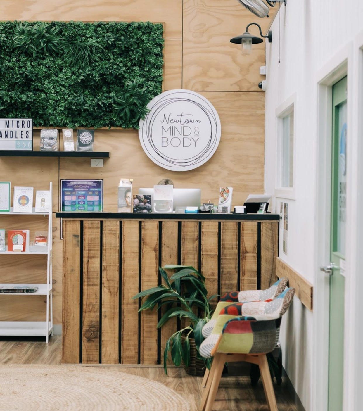 Reception desk with plant wall and Newtown Mind & Body signage