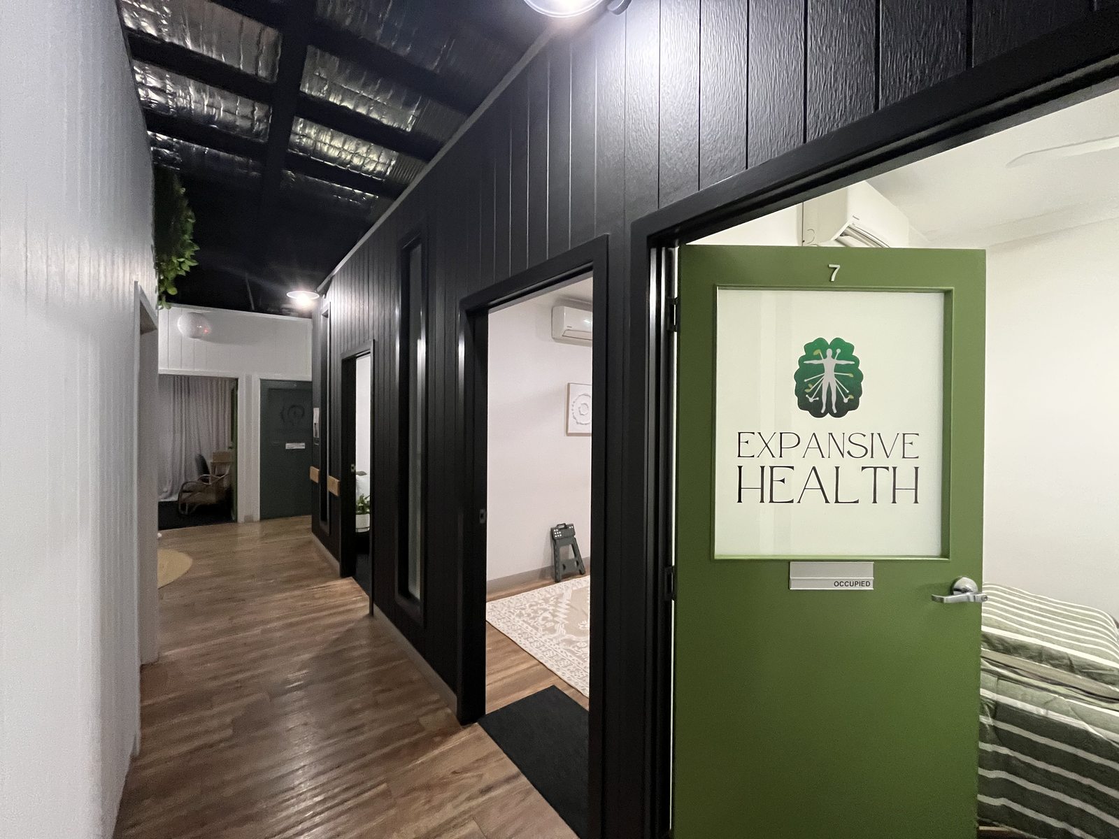 Room 7, Expansive Health, with green door signage